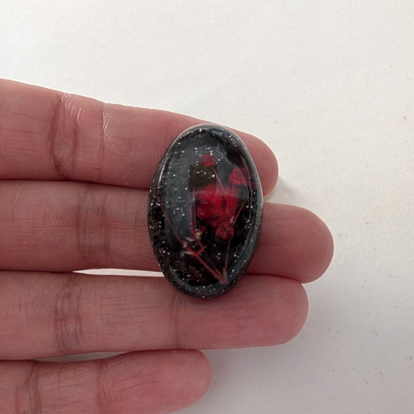 Add a touch of nature to your outfit with our Pin - 3D dried flower resin pin. The intricate design and 3D effect will surely catch everyone's eye. With the sturdy silver butterfly clutch, your pin will stay securely in place. Elevate your style with this unique and beautiful accessory.