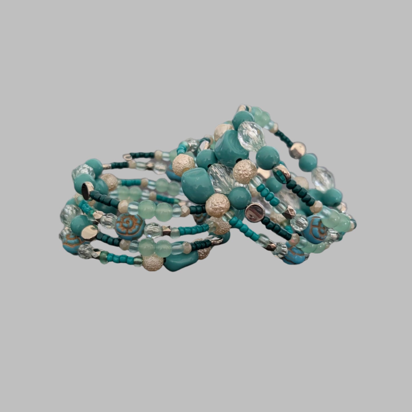 Elevate your style with this stunning 4-coil memory wire bracelet featuring a harmonious blend of turquoise, white, and crystal beads. Its flexible design ensures a comfortable fit for any wrist, while the sparkling crystals add a touch of elegance to any outfit. Perfect for layering or wearing alone, this bracelet effortlessly combines durability with eye-catching beauty.