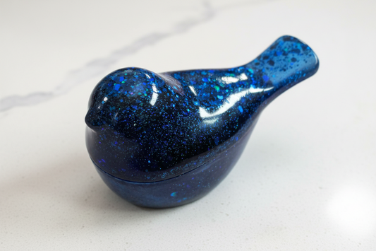 A blue resin bird with lid trinket