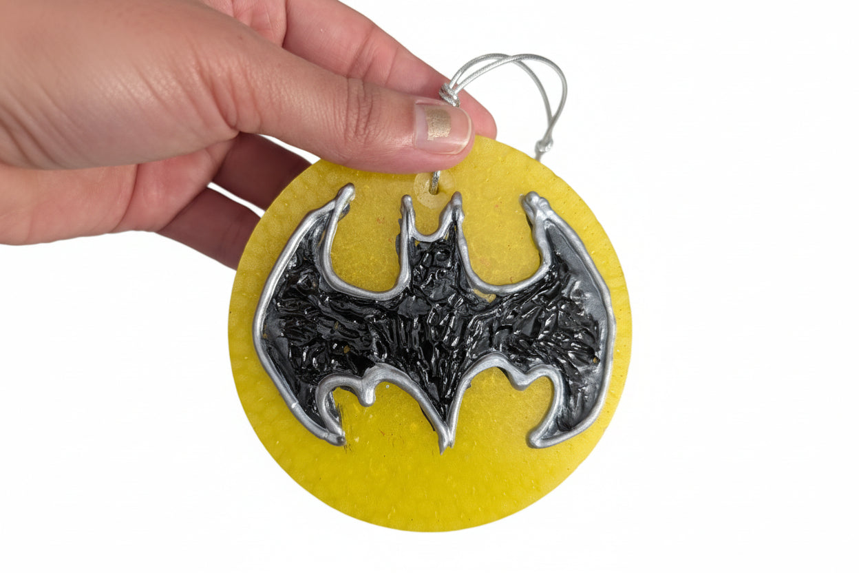 Gotham just got fresher! Channel your inner Dark Knight with this bold Batman Freshie. Sized at a compact 3.5 x 3.5 inches and weighing 2.6 oz, this superhero-inspired air freshener fits perfectly in your car, locker, or anywhere you need a dash of heroic style. Experience up to 6 months of long-lasting fragrance that keeps your space smelling amazing. A decorative must-have for comic book fans and Bat-enthusiasts alike. Display only—keep away from children and pets, and never ingest. Suit up your space wit