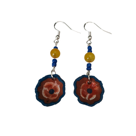 Add a pop of playful charm to your outfit with these Small Mexican plate earrings. Featuring delicate ceramic plates adorned with crystal and seed beads, these silver hook earrings measure 2.5 inches in length and weigh just 0.09 oz. Perfect for adding a touch of quirkiness to any look!