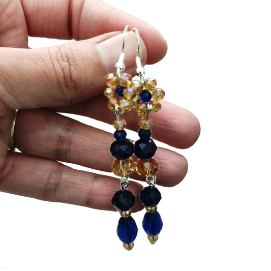 Add a touch of elegance to your outfit with these stunning earrings! The flower gold and navy long bead earrings on silver hook feature crystal beads that will catch the light and sparkle. With a length of approximately 3 inches and weighing only 0.23 oz, they are lightweight and comfortable for all-day wear. Elevate your style with these beautiful earrings now!
