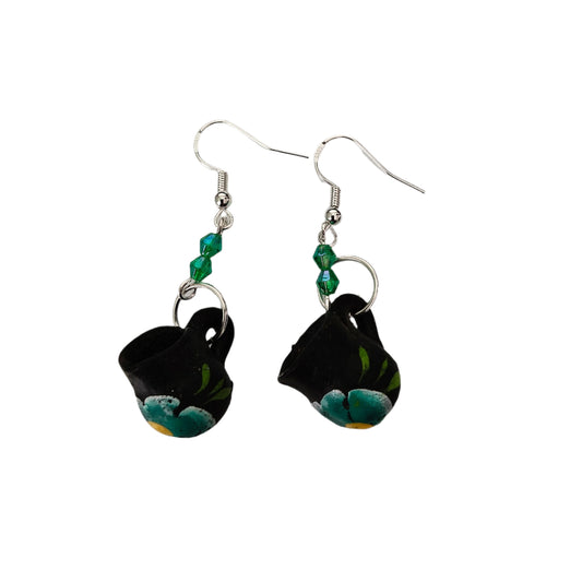 These quirky earrings feature a ceramic Mexican mug with colorful beads hanging from a silver hook. With a length of approximately 2 inches and a weight of only 0.14 oz, they are lightweight and comfortable to wear. Perfect for adding a unique touch to any outfit!