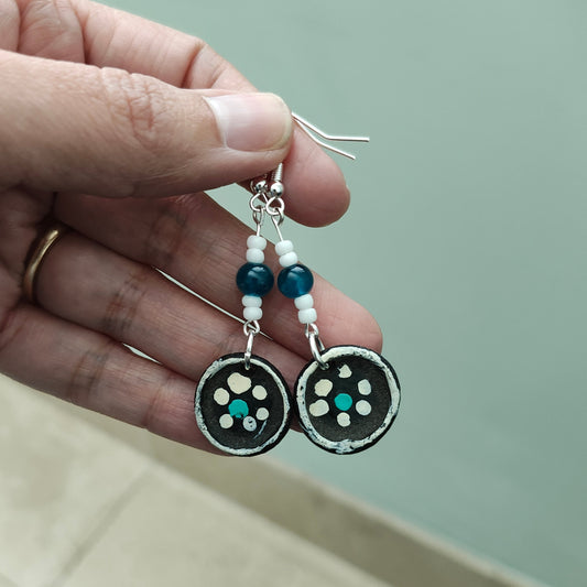 Add a touch of whimsy to your look with these playful earrings featuring ceramic plates adorned with crystal and seed beads. Suspended from silver hooks, these 2.5 inch long earrings are lightweight at just 0.12 oz. Make a statement with these unique earrings!