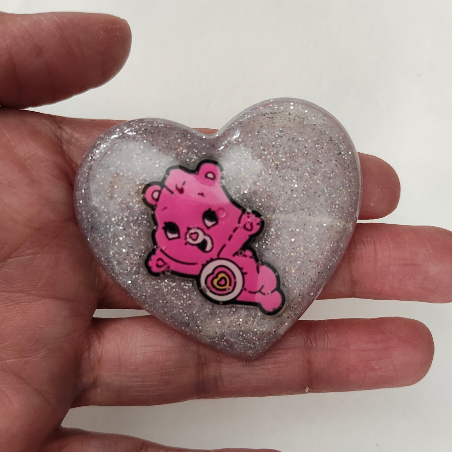 Add a playful touch to your outfit with our 3D care bear resin pin! This quirky accessory features a silver butterfly clutch and is sized at 1.75 x 2 inches, making it the perfect statement piece. Weighing at only 0.40 oz, it won't weigh you down.
Pin - 3D care bear resin pin with silver butterfly clutch