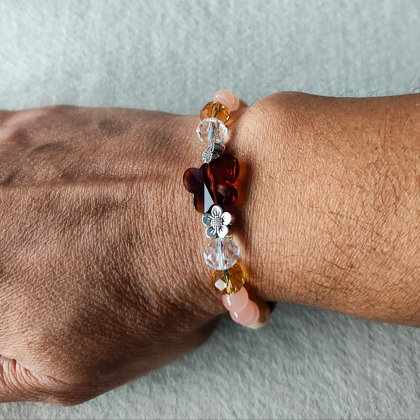 Bracelet - Elastic Crystal butterfly bead with brown, white, & pink beads and flower metal spacer beads