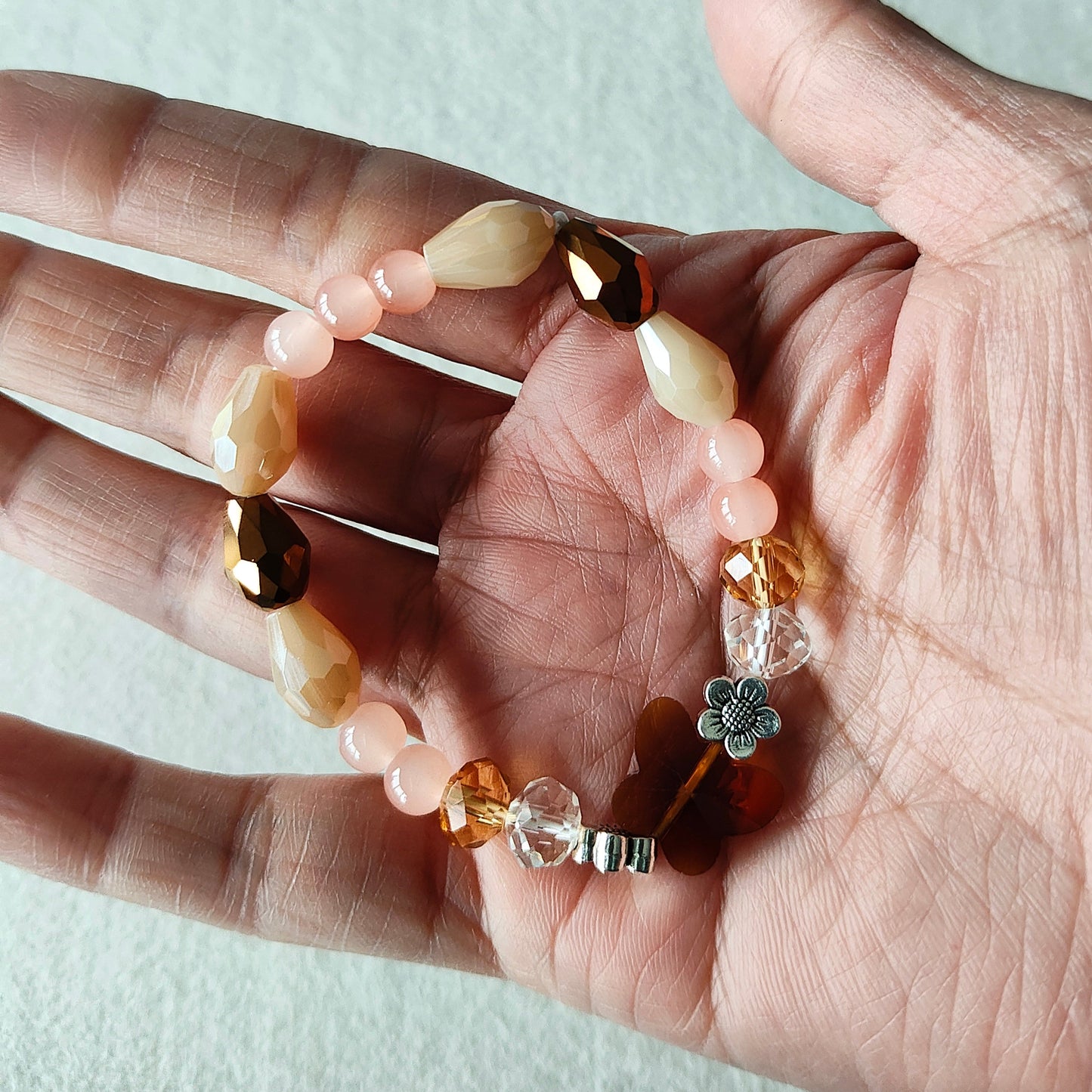 Bracelet - Elastic Crystal butterfly bead with brown, white, & pink beads and flower metal spacer beads