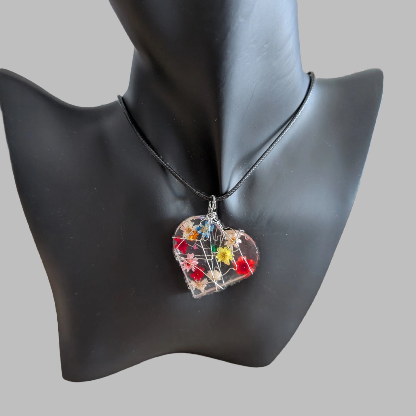 Necklace - 17.5 inches clear resin with dried flowers heart on black cord