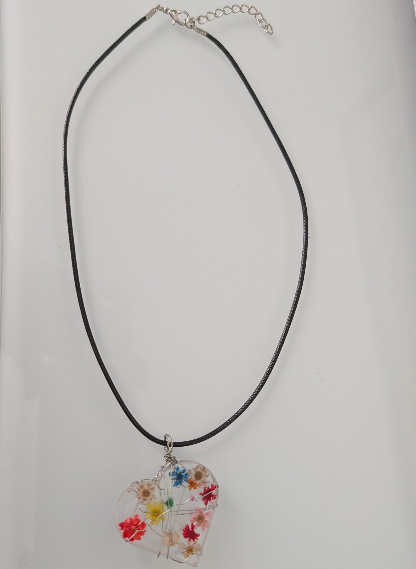 Necklace - 17.5 inches clear resin with dried flowers heart on black cord