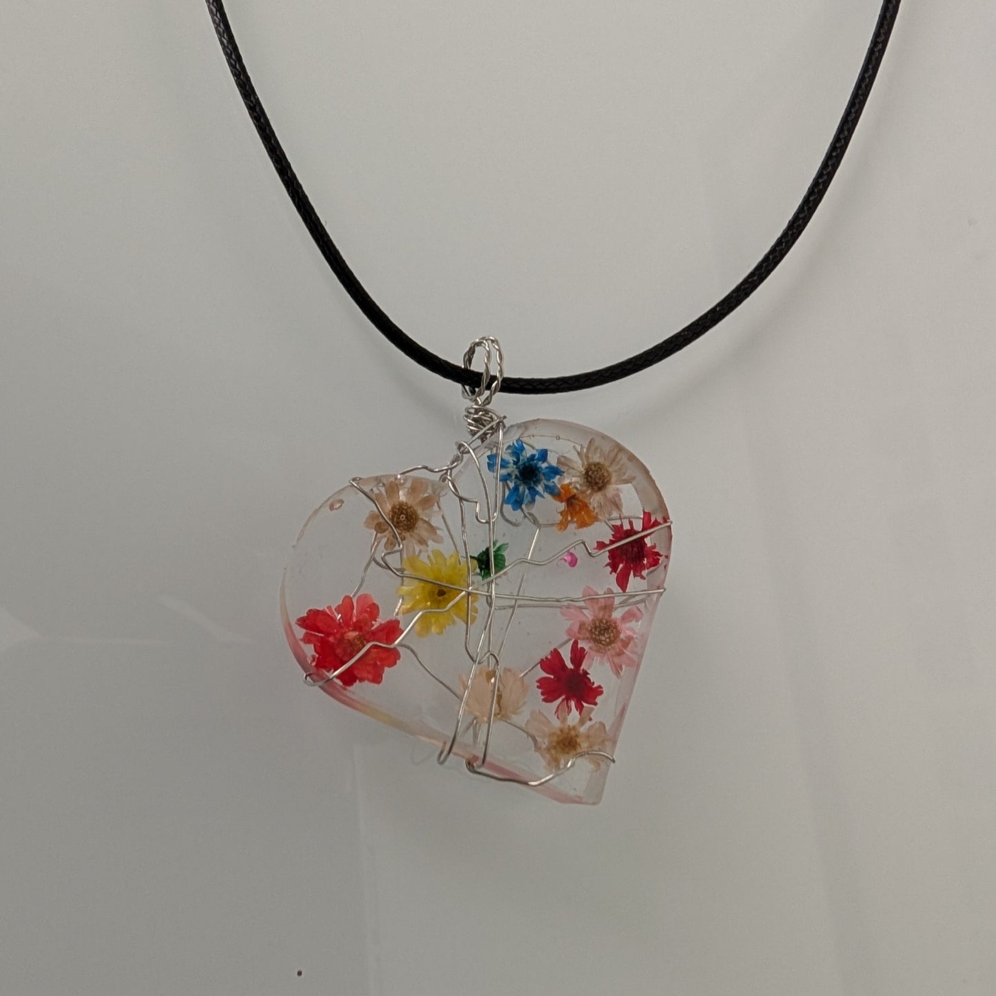 Necklace - 17.5 inches clear resin with dried flowers heart on black cord