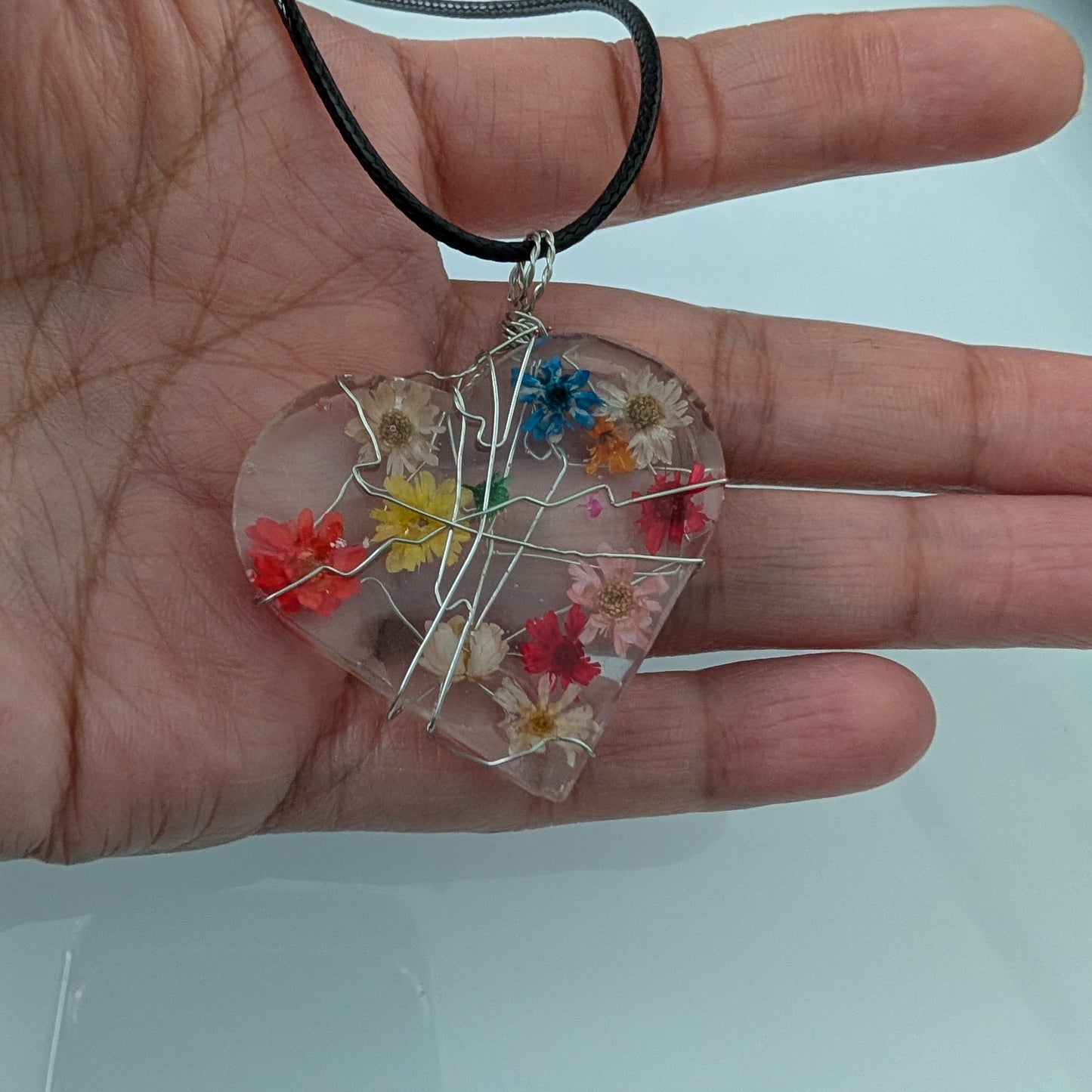 Necklace - 17.5 inches clear resin with dried flowers heart on black cord