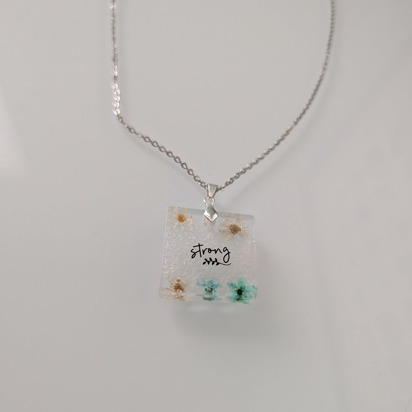 Necklace - 21 inches stainless steel cable link chain with a resin with flowers square pendant