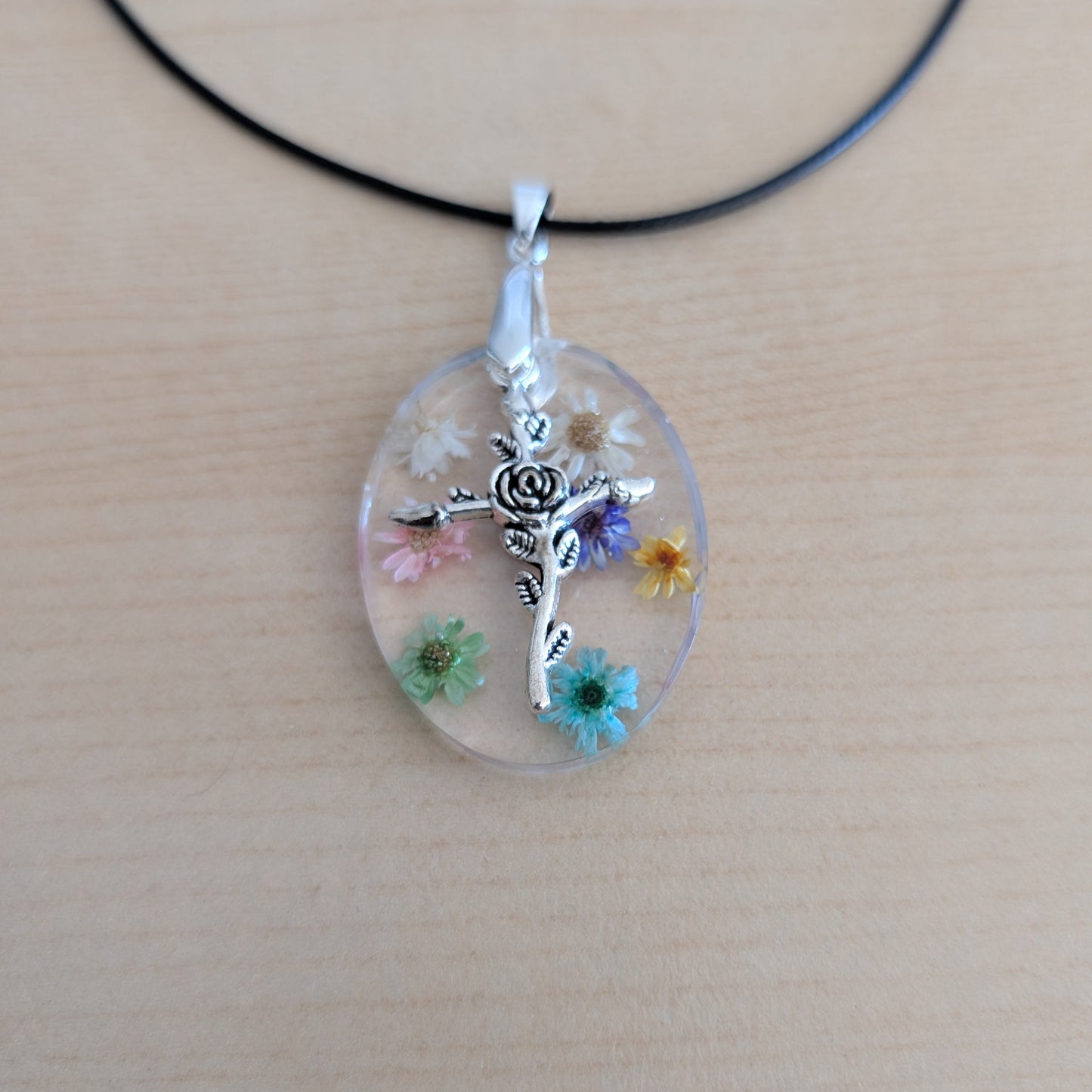 Necklace - 17.5 inches resin oval with flowers and silver cross charm on black leather cord with clasp