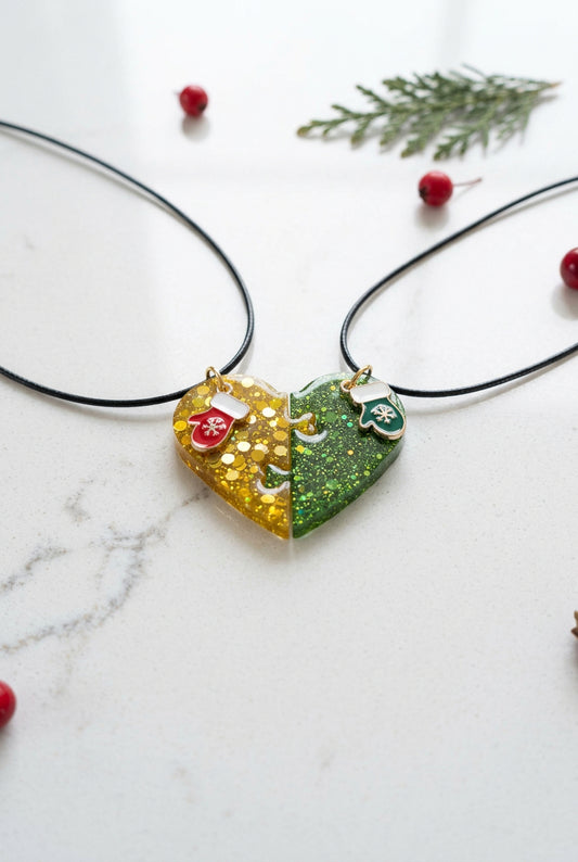 Necklace - 17.5 inches black waxed cord with two resin half hearts and a Christmas charm