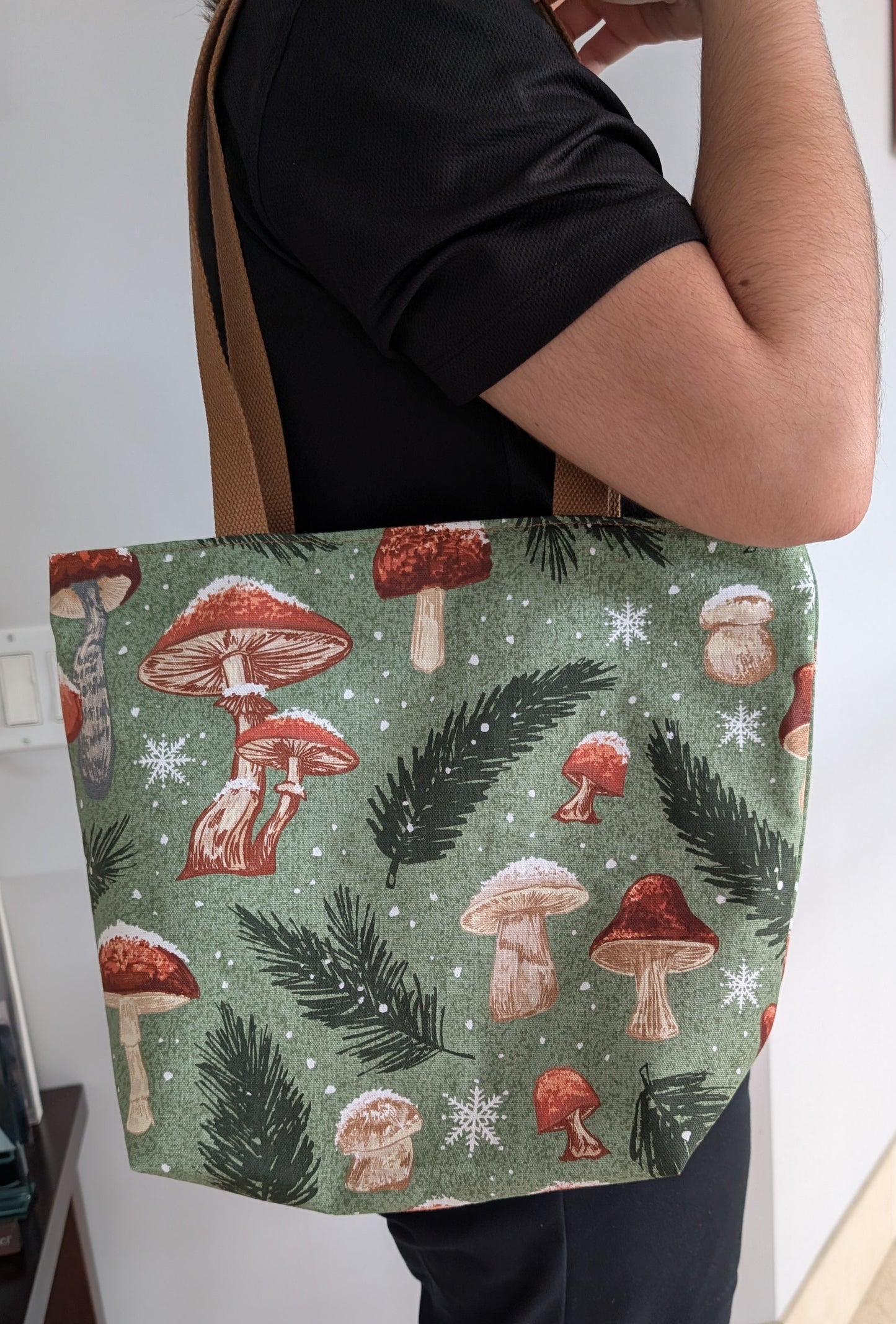 Snowy Mushrooms bag with orange lining one inner pocket and zipper closure