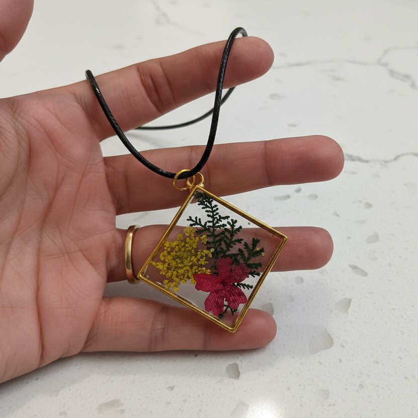 Necklace - 17.5 inches resin and flowers gold pendant on black cord
