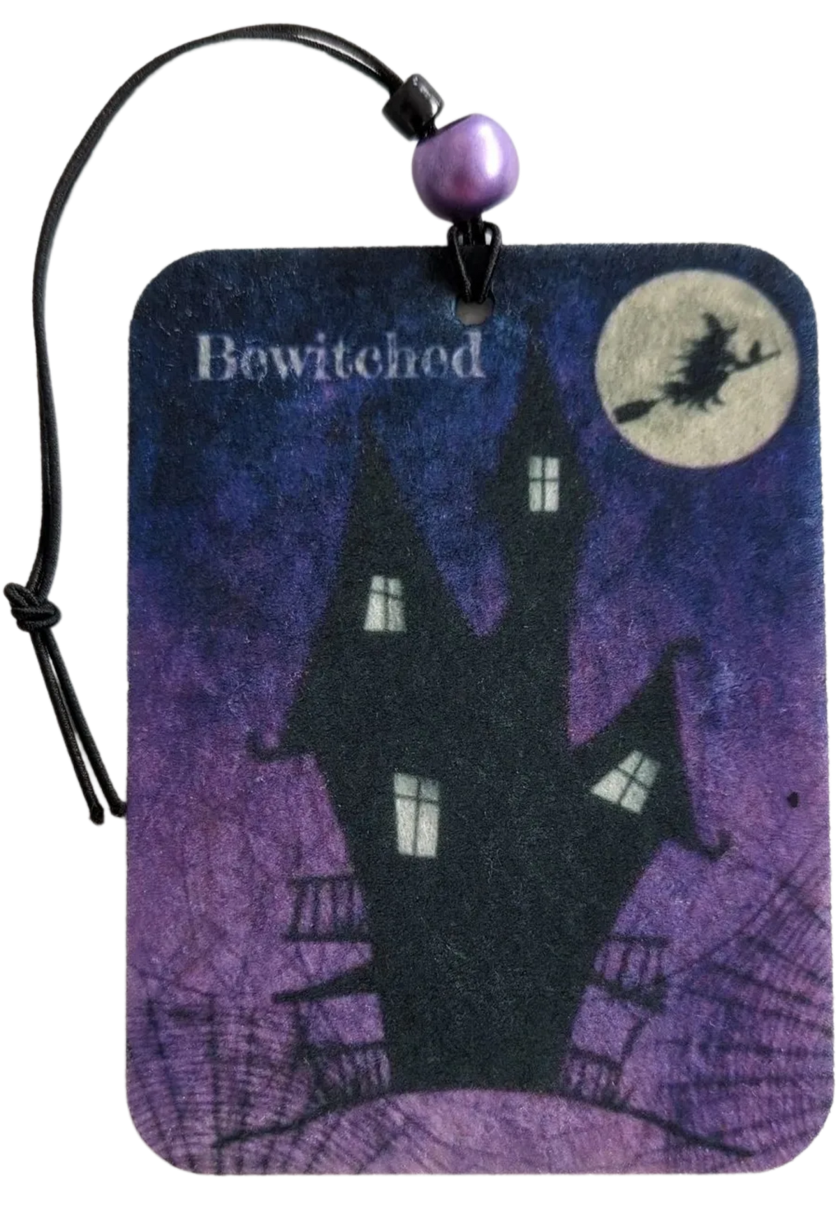 A rectangular car ornament with a 'Bewitched' theme, featuring a haunted house and a witch on a purple background.