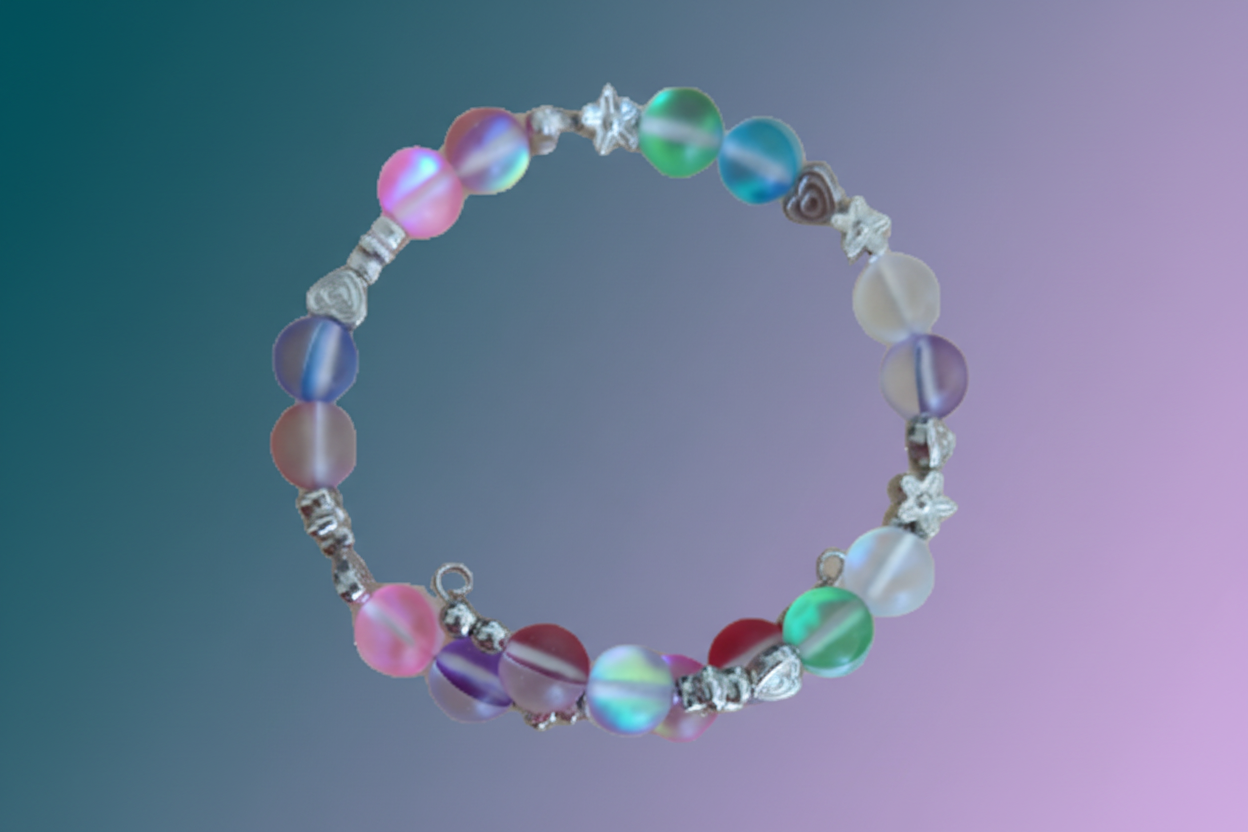 A multicolored bracelet made of glass and metal beads on a silver memory wire band.