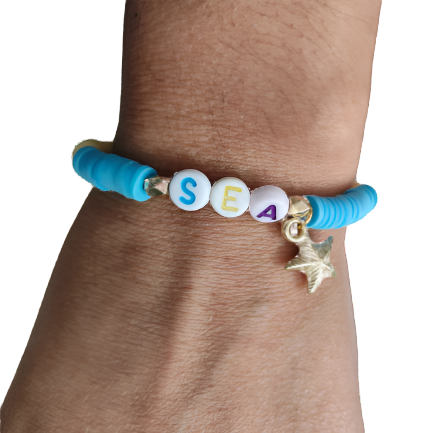 Bracelet - Elastic "Sea" with colorful clay beads and gold spacer beads and a starfish charm