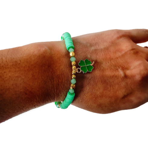Bracelet - Medium 7.5 inches elastic green & yellow clay beads and gold spacer beads and a four leaf clover charm