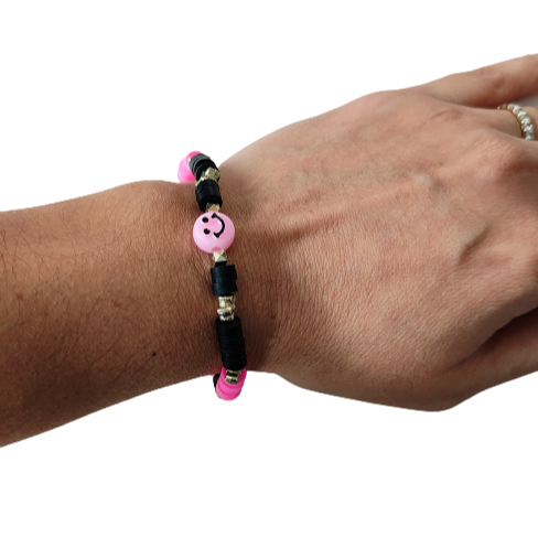 Bracelet - Elastic pink & black clay beads and gold spacer beads and a happy face acrylic bead