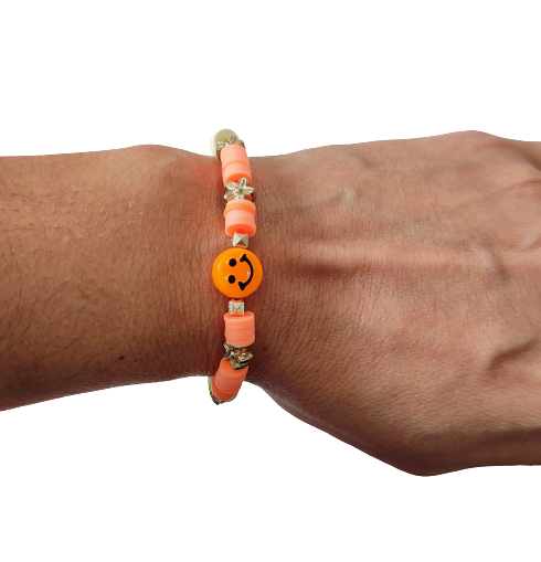 Bracelet - Elastic orange & yellow clay beads and gold spacer beads and a happy face acrylic bead