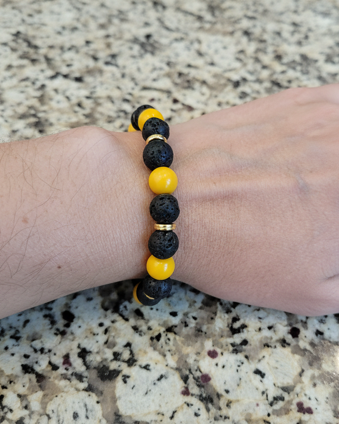 Bracelet - Elastic black volcanic beads and yellow glass beads with gold spacer beads