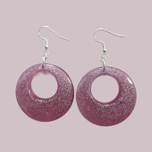 A pair of pink resin open chunky circle earrings on silver hooks.