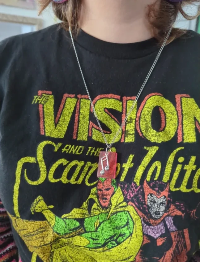 Necklace - 23.5 inches small red glitter resin rectangle with silver music note charm on stainless steel curb chain