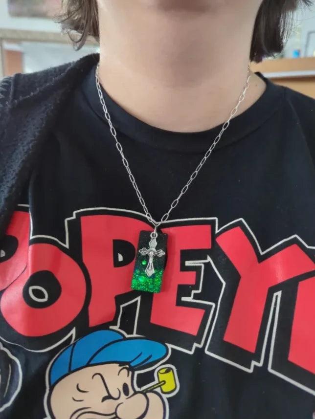 Necklace - 18.5 inches black green glitter resin rectangle with silver cross charm on silver paperclip cable chain