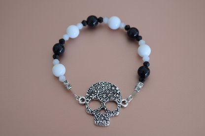Bracelet - Elastic black & white glass beads and bicone beads with silver skeleton face charm