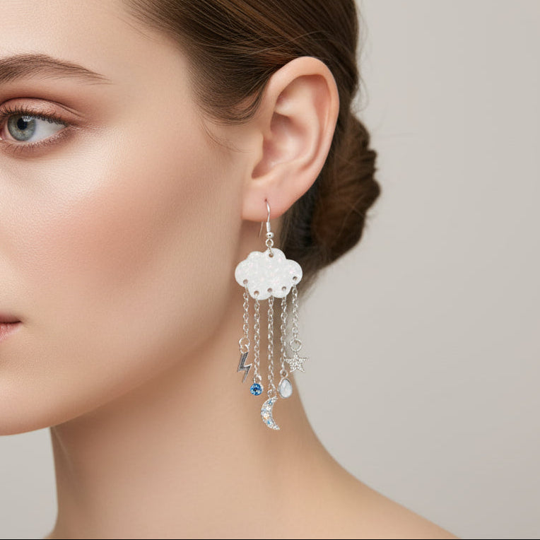 Close-up of a woman wearing a cloud-shaped earring with dangling charms.
