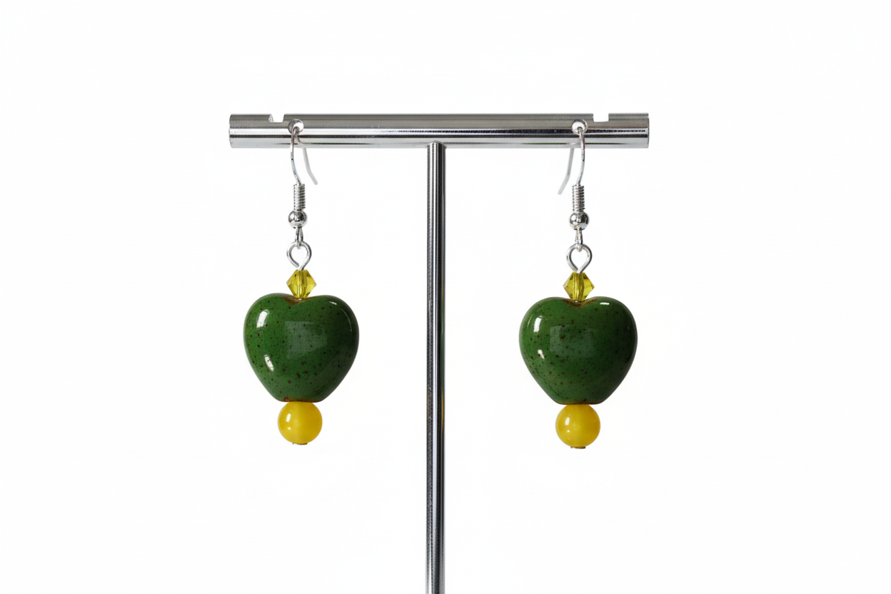 A pair of chunky heart-shaped bead earrings with yellow crystal beads on a silver hook.