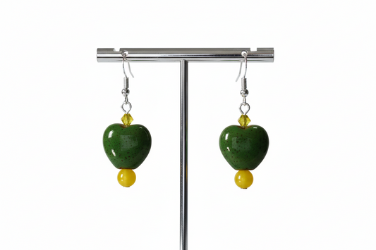 A pair of chunky heart-shaped bead earrings with yellow crystal beads on a silver hook.