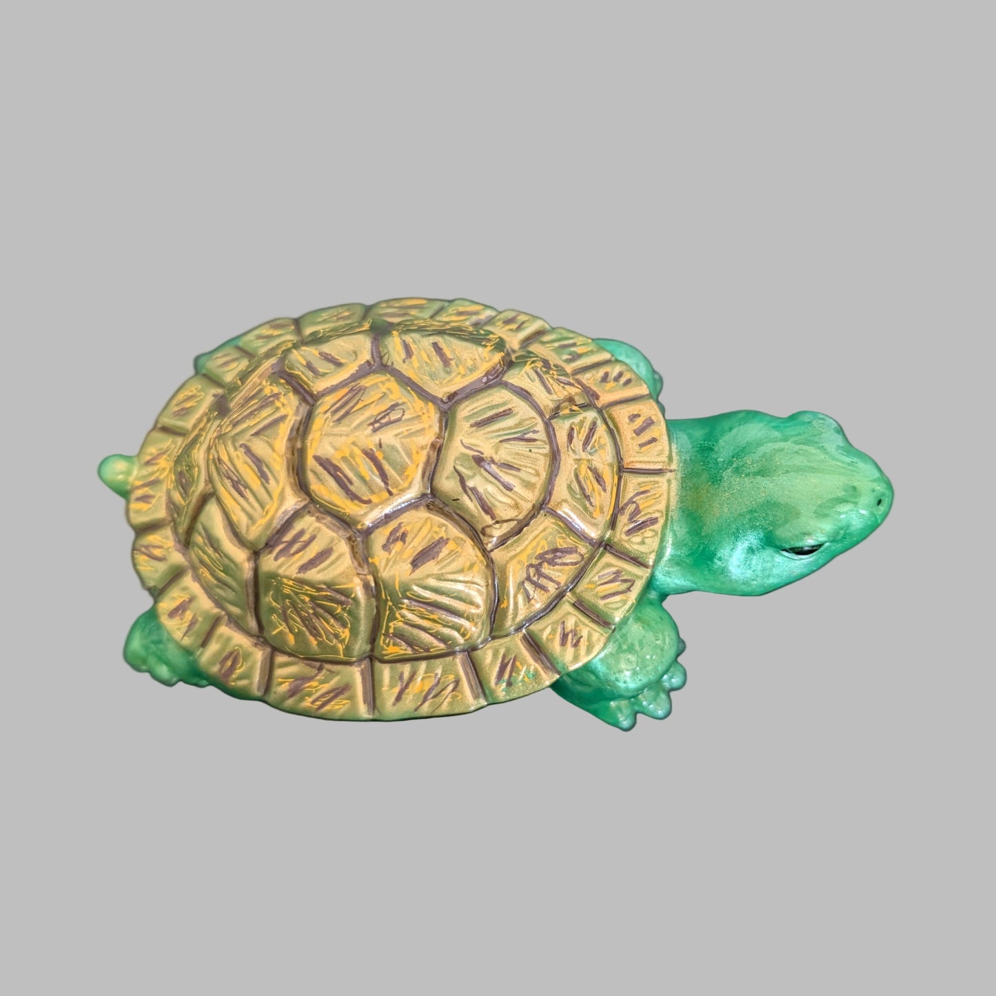 This charming resin turtle knickknack, measuring approximately 3 by 5.5 inches with a height of 2 inches, is a perfect decorative piece for any space.