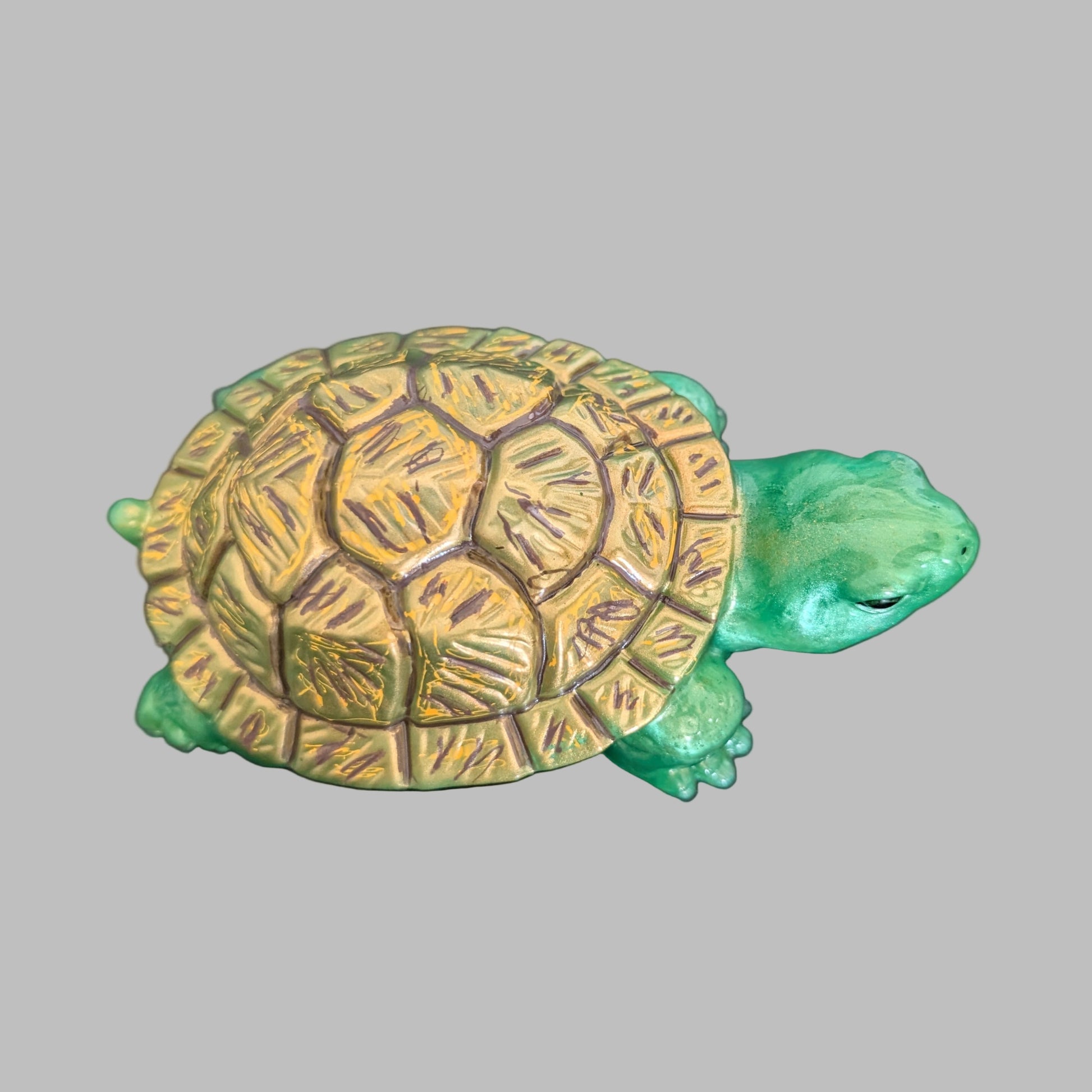This charming resin turtle knickknack, measuring approximately 3 by 5.5 inches with a height of 2 inches, is a perfect decorative piece for any space.