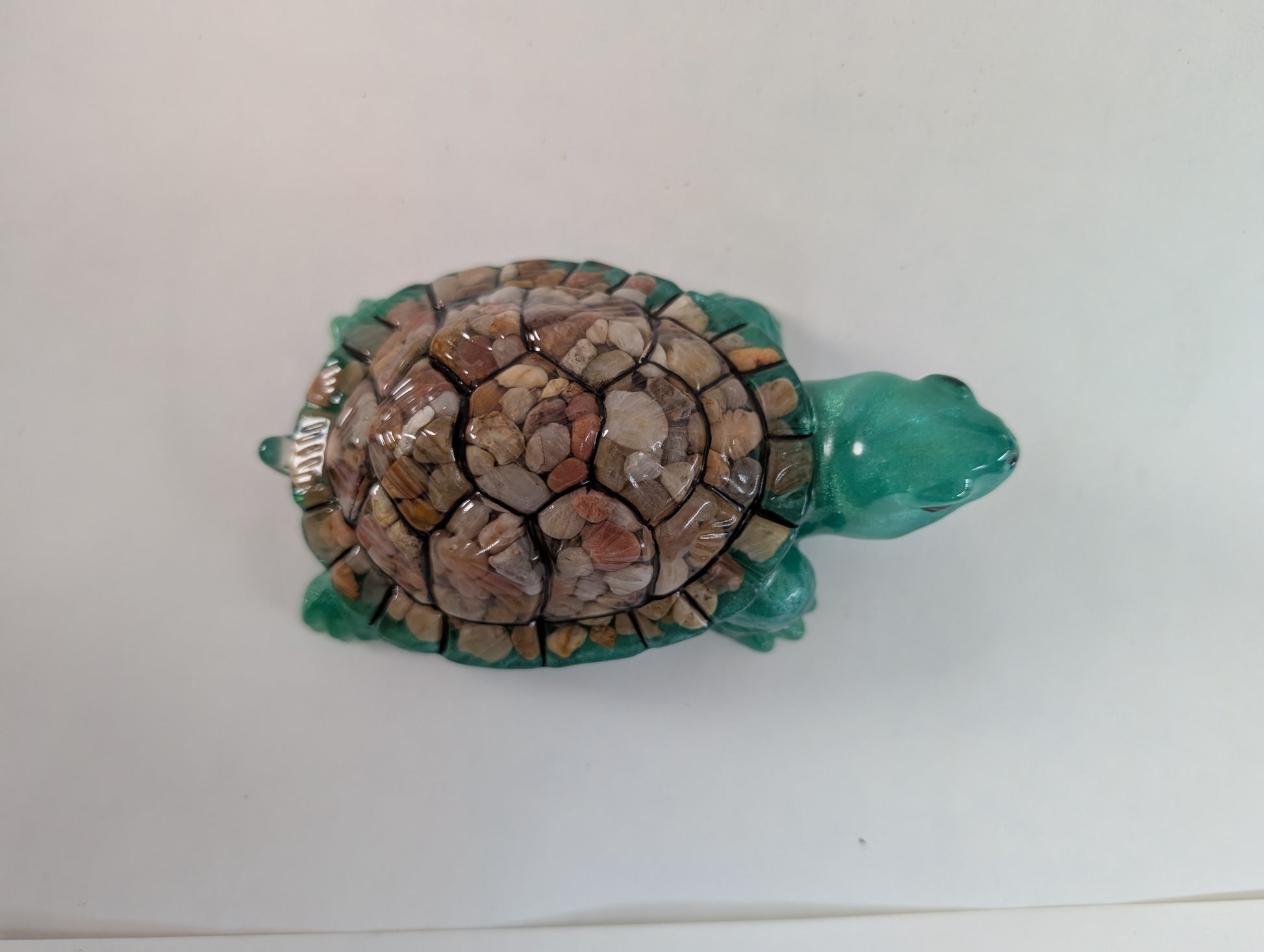 This charming resin turtle knickknack, measuring approximately 3 by 5.5 inches with a height of 2 inches, is a perfect decorative piece for any space.