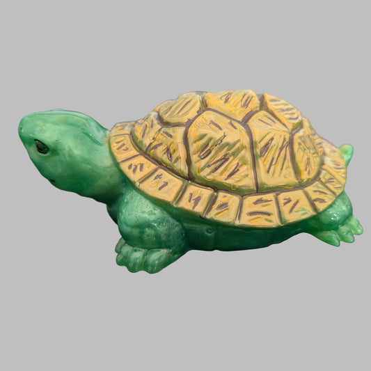 This charming resin turtle knickknack, measuring approximately 3 by 5.5 inches with a height of 2 inches, is a perfect decorative piece for any space.
