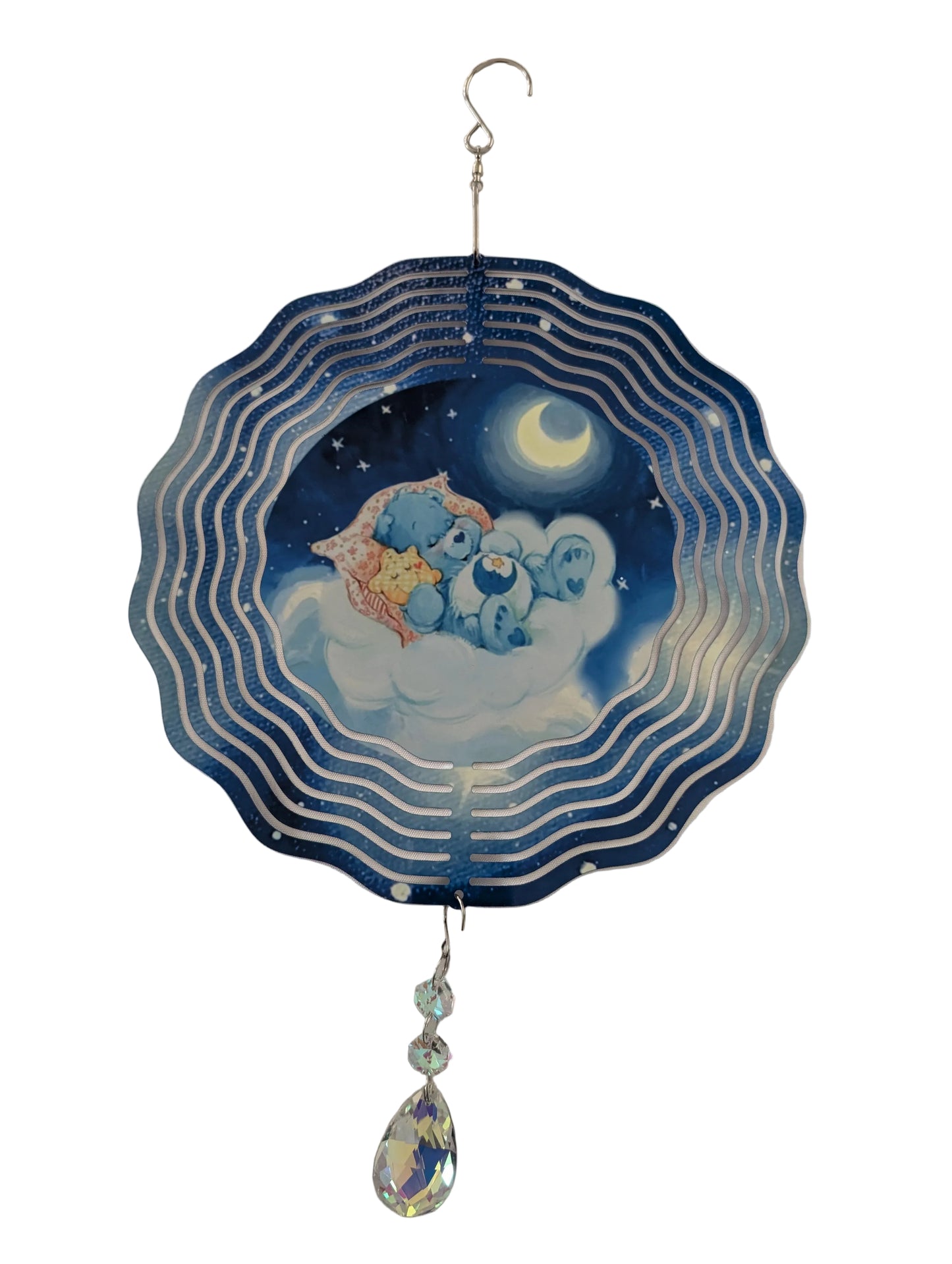 Bring whimsical charm to your outdoor space with this delightful 10-inch wind spinner showcasing Bedtime Care Bear on both sides. As it spins gracefully, stunning 4-inch teardrop crystal prisms dance with light, casting rainbow sparkles across your garden. Crafted from lightweight yet robust aluminum with a protective powder-coated finish, this spinner laughs in the face of rust and corrosion. The UV-treated image stays vibrant and cheerful through countless sunny days. Safe, smooth edges and hassle-free se