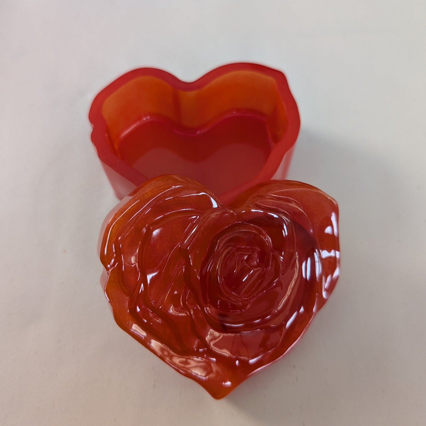 Elevate your space with this Resin Rose Lid Trinket Box, a charming blend of elegance and practicality. Its delicate resin rose lid adds a touch of timeless beauty, while the compact design keeps your small treasures organized and within reach. Perfect for jewelry, keepsakes, or special mementos, this trinket box makes a thoughtful gift or a stylish addition to your own collection. Add a graceful accent to your décor and keep your cherished items safe in style.