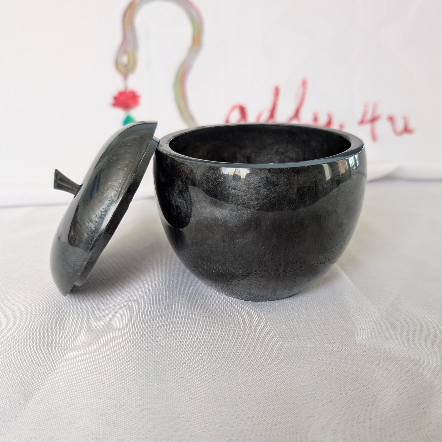 hand crafted with epoxy resin..

Epoxy resin is typically smooth, rigid, and non-porous, similar to a hard plastic or glass.

Knickknack - Resin apple trinket with lid