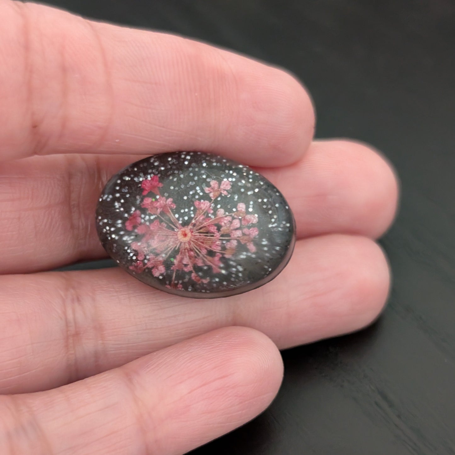 Add a touch of nature to your outfit with our Pin - 3D dried flower resin pin. The intricate design and 3D effect will surely catch everyone's eye. With the sturdy silver butterfly clutch, your pin will stay securely in place. Elevate your style with this unique and beautiful accessory.