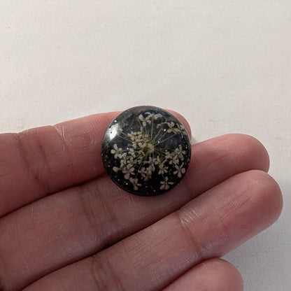 Add a touch of nature to your outfit with our Pin - 3D dried flower resin pin. The intricate design and 3D effect will surely catch everyone's eye. With the sturdy silver butterfly clutch, your pin will stay securely in place. Elevate your style with this unique and beautiful accessory.