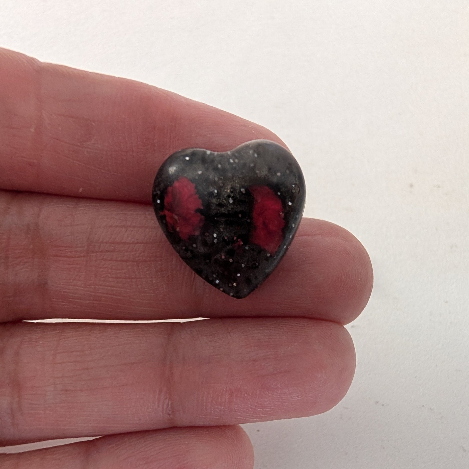 Add a touch of nature to your outfit with our Pin - 3D dried flower resin pin. The intricate design and 3D effect will surely catch everyone's eye. With the sturdy silver butterfly clutch, your pin will stay securely in place. Elevate your style with this unique and beautiful accessory.