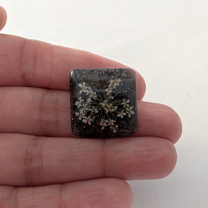 Add a touch of nature to your outfit with our Pin - 3D dried flower resin pin. The intricate design and 3D effect will surely catch everyone's eye. With the sturdy silver butterfly clutch, your pin will stay securely in place. Elevate your style with this unique and beautiful accessory.