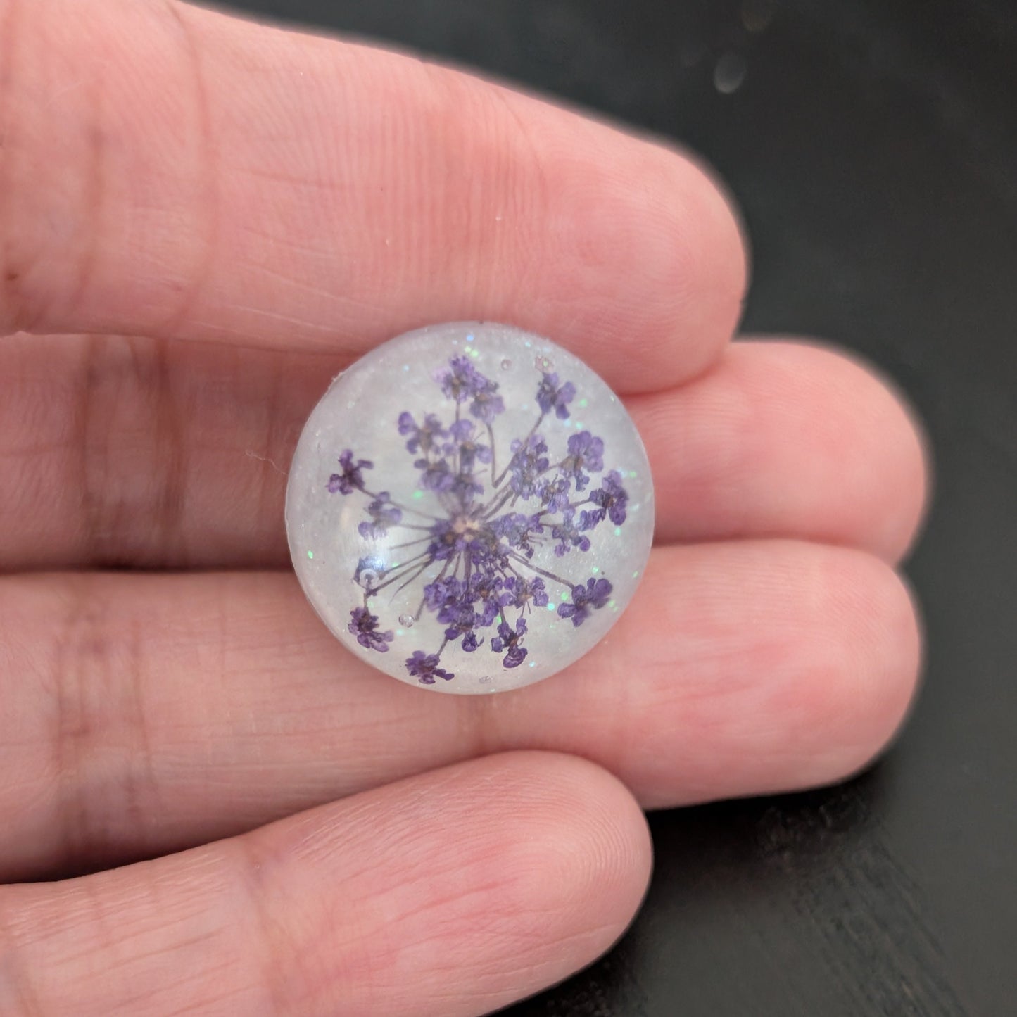 Add a touch of nature to your outfit with our Pin - 3D dried flower resin pin. The intricate design and 3D effect will surely catch everyone's eye. With the sturdy silver butterfly clutch, your pin will stay securely in place. Elevate your style with this unique and beautiful accessory.