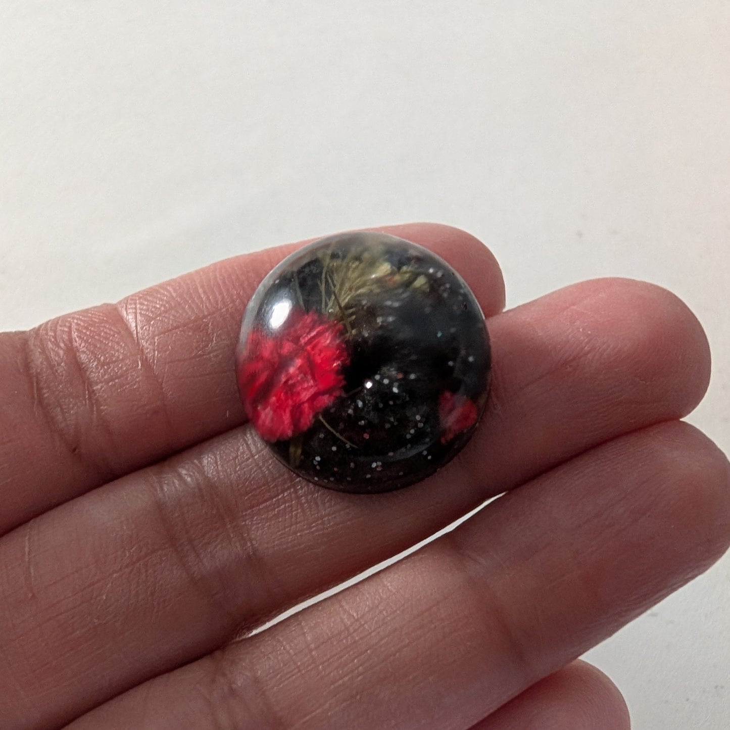 Add a touch of nature to your outfit with our Pin - 3D dried flower resin pin. The intricate design and 3D effect will surely catch everyone's eye. With the sturdy silver butterfly clutch, your pin will stay securely in place. Elevate your style with this unique and beautiful accessory.