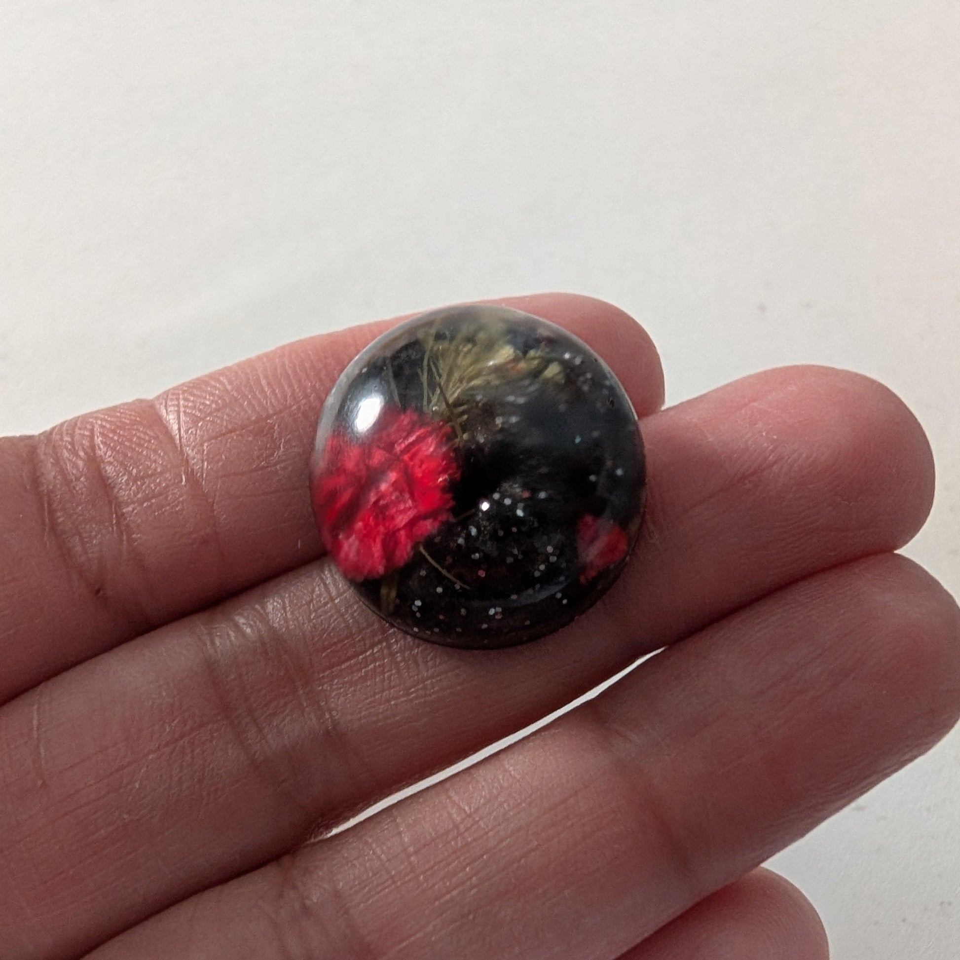 Add a touch of nature to your outfit with our Pin - 3D dried flower resin pin. The intricate design and 3D effect will surely catch everyone's eye. With the sturdy silver butterfly clutch, your pin will stay securely in place. Elevate your style with this unique and beautiful accessory.