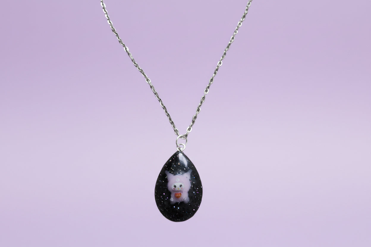 This stunning necklace features a 16.5 inch stainless steel link cable chain with a charming resin Kuromi character pendant. Crafted with quality materials, this necklace is both durable and stylish. Upgrade your accessory game with this unique and eye-catching piece.