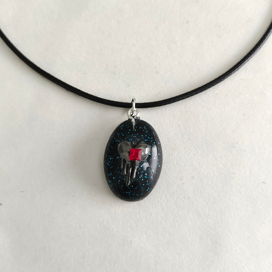 This stunning necklace features a 17.5 inch black waxed cord that is both sleek and durable. The resin and silver charm pendant adds a touch of elegance and charm to any outfit. An effortless way to make a statement.